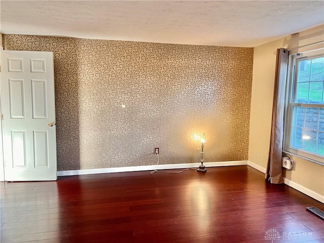 5 Devon Ct, Fairfield, OH 45014 - empty room with wallpapered walls, hardwood / wood-style floors, baseboards, and a textured ceiling
