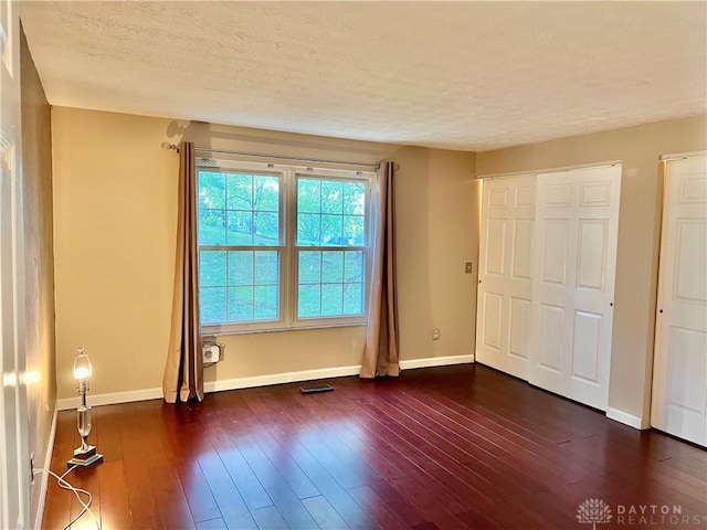 5 Devon Ct, Fairfield, OH 45014 - unfurnished bedroom featuring baseboards, a textured ceiling, and dark wood-style floors