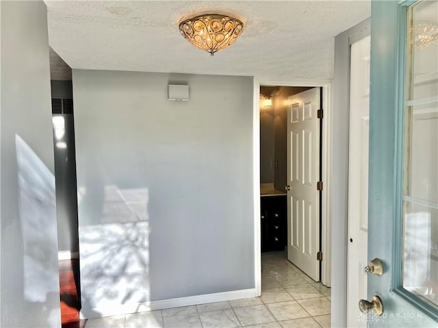 5 Devon Ct, Fairfield, OH 45014 - corridor featuring a textured ceiling, baseboards, and light marble finish floors