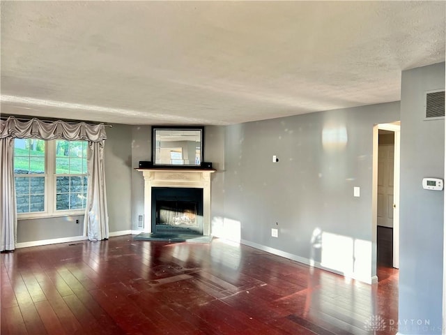 5 Devon Ct, Fairfield, OH 45014 - unfurnished living room featuring a fireplace with raised hearth, hardwood / wood-style floors, baseboards, and a textured ceiling