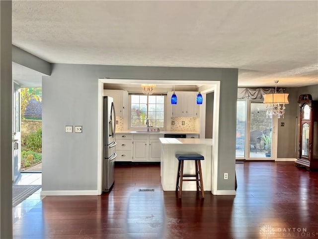 5 Devon Ct, Fairfield, OH 45014 - kitchen featuring a chandelier, stainless steel refrigerator with ice dispenser, light countertops, a sink, and a textured ceiling