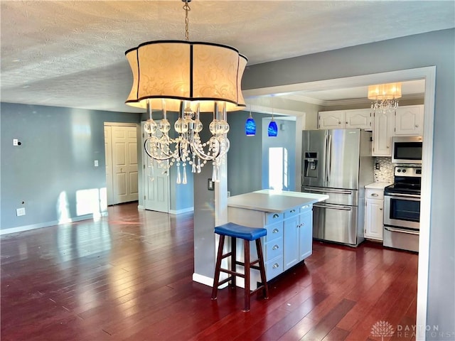 5 Devon Ct, Fairfield, OH 45014 - kitchen with stainless steel appliances, a chandelier, white cabinets, a textured ceiling, and crown molding