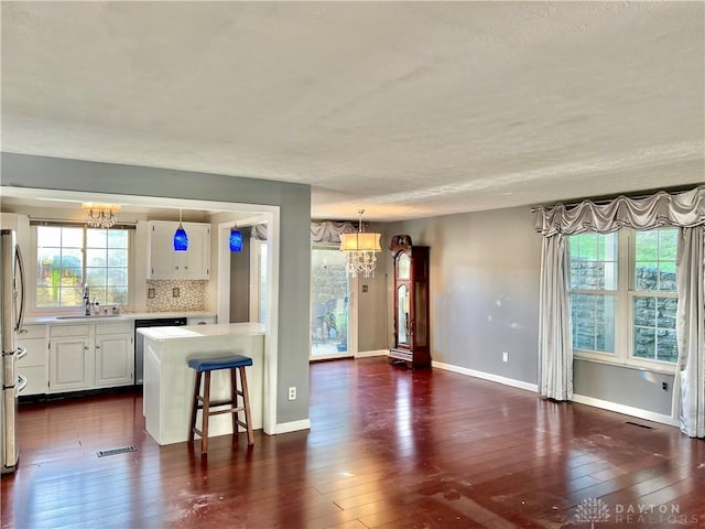 5 Devon Ct, Fairfield, OH 45014 - kitchen with a chandelier, a sink, light countertops, stainless steel appliances, and a textured ceiling
