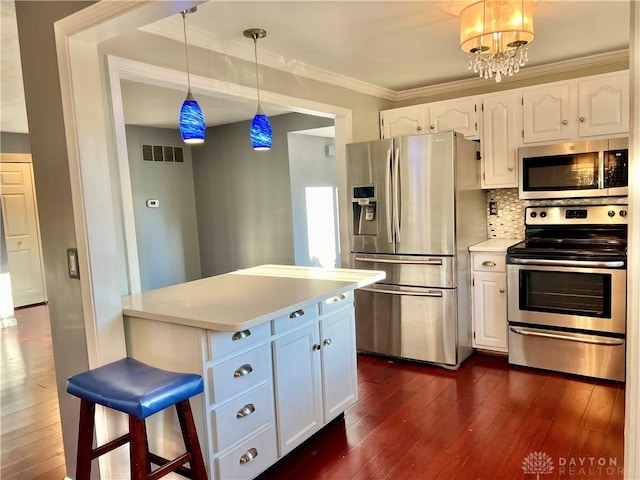 5 Devon Ct, Fairfield, OH 45014 - kitchen with stainless steel appliances, white cabinetry, dark wood-style floors, light countertops, and crown molding