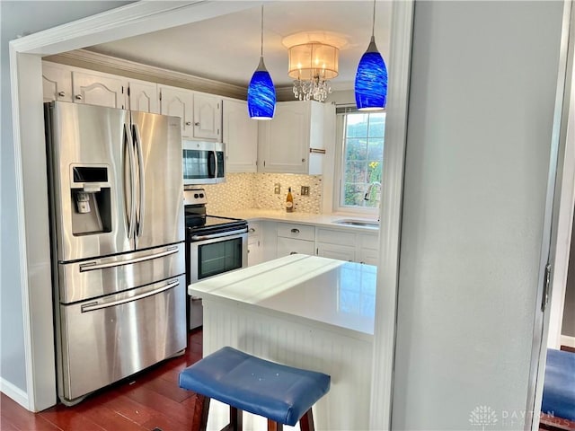 5 Devon Ct, Fairfield, OH 45014 - kitchen featuring appliances with stainless steel finishes, white cabinets, dark wood finished floors, a chandelier, and tasteful backsplash