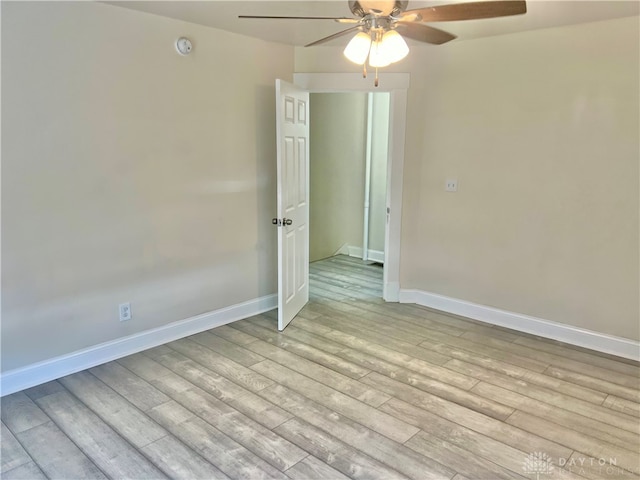 spare room featuring light hardwood / wood-style flooring and ceiling fan