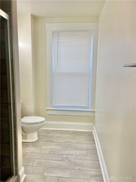 bathroom featuring toilet and hardwood / wood-style floors