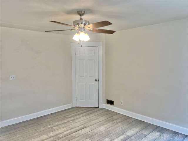 spare room with ceiling fan and light wood-type flooring