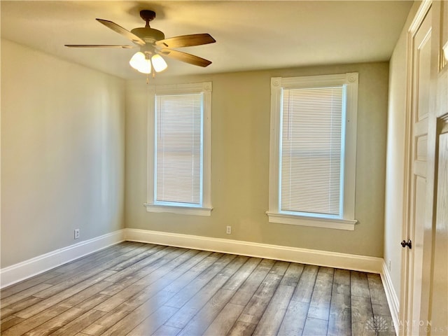 empty room featuring hardwood / wood-style floors and ceiling fan