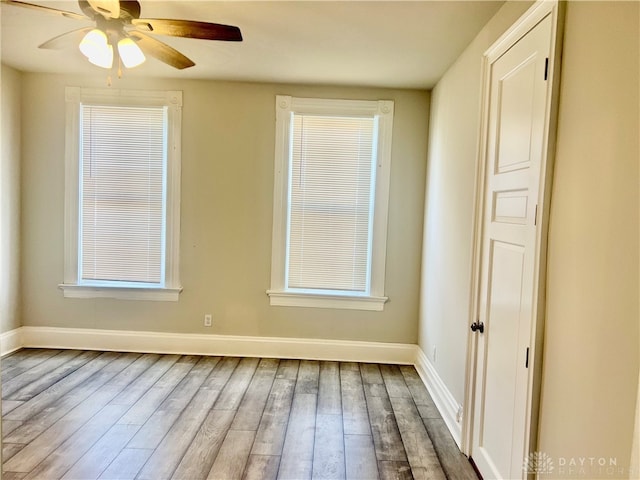 empty room featuring hardwood / wood-style floors and ceiling fan