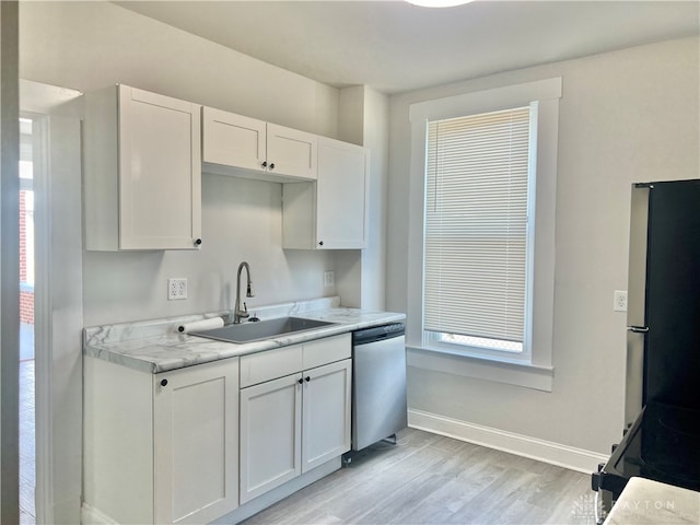 kitchen with white cabinetry, stainless steel appliances, sink, and light wood-type flooring