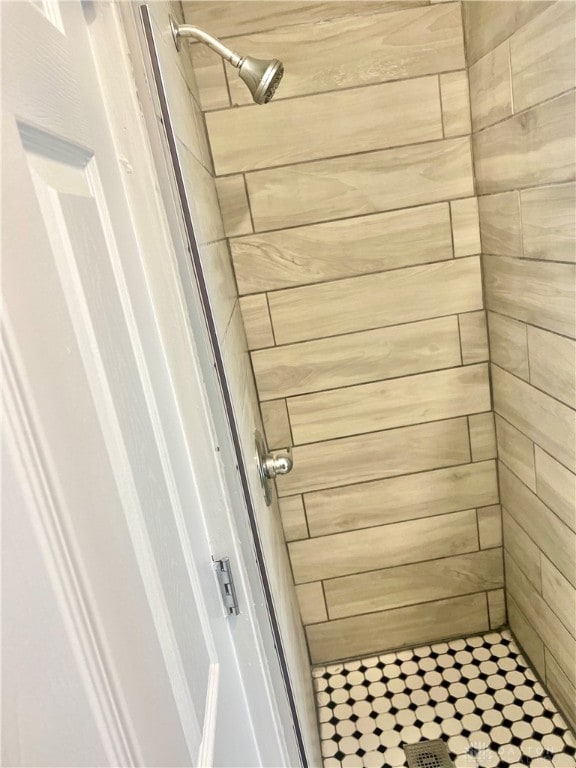 bathroom with a tile shower