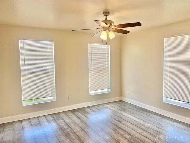 unfurnished room with ceiling fan and light wood-type flooring