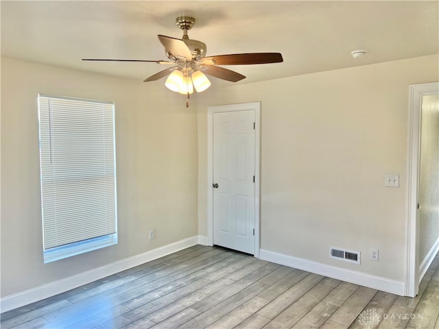 spare room with light wood-type flooring and ceiling fan