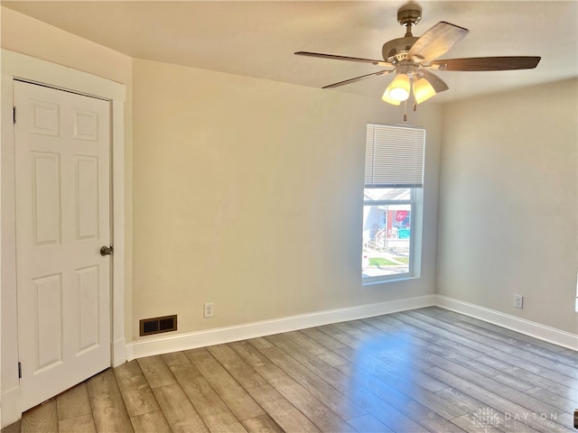 unfurnished room featuring ceiling fan and hardwood / wood-style floors