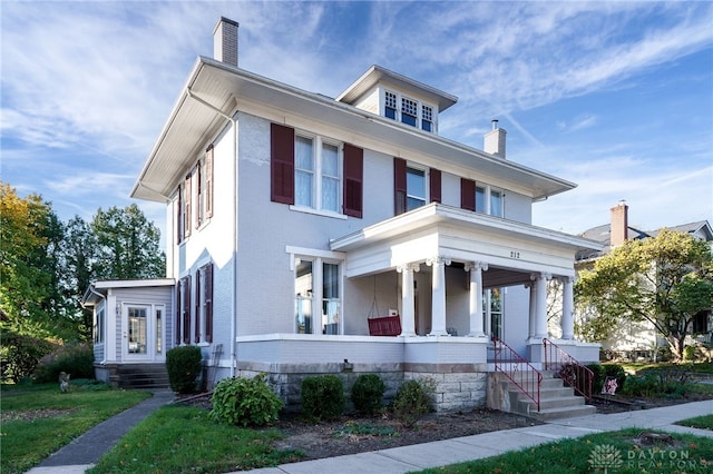 view of front of house featuring a front yard and a porch