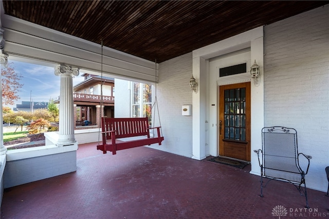 exterior space featuring a porch and brick siding