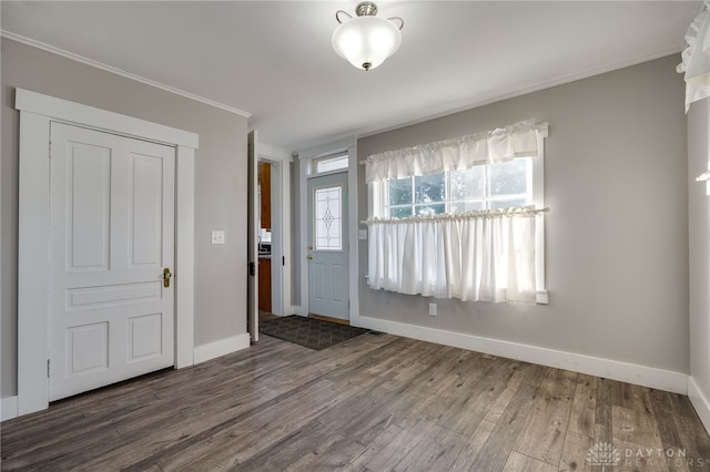 foyer with plenty of natural light, crown molding, and wood finished floors