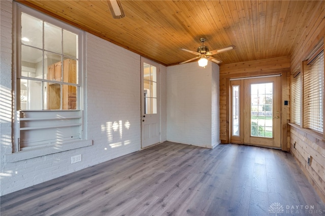 unfurnished sunroom with wooden ceiling and ceiling fan