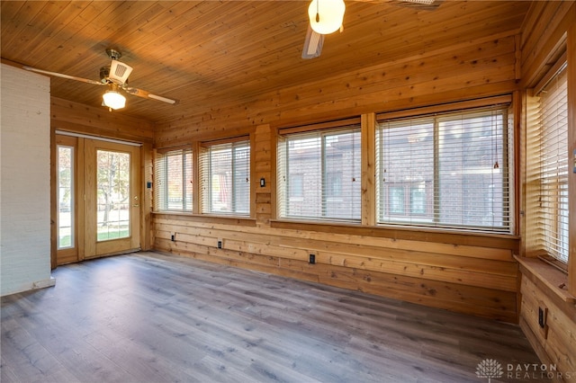 unfurnished sunroom featuring a ceiling fan and wooden ceiling