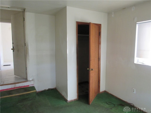 unfurnished bedroom with a closet and carpet