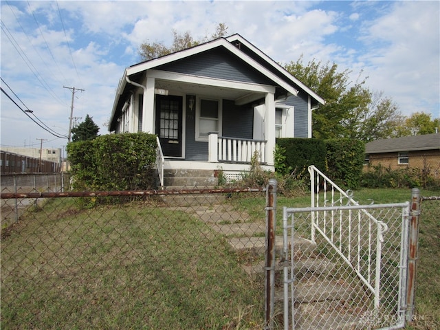 bungalow with a porch and a front lawn