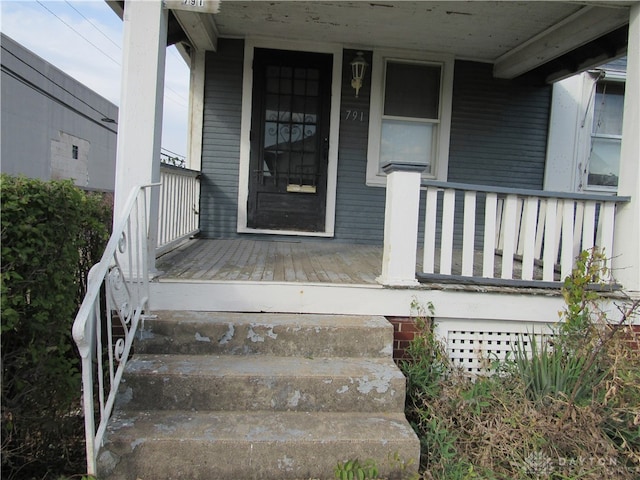 view of exterior entry with covered porch