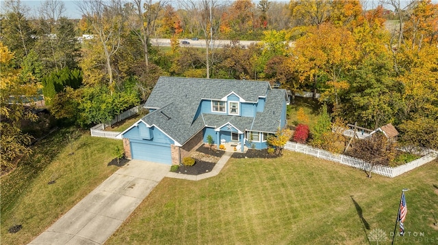 view of front of home with a front lawn and a garage