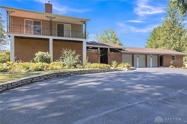 view of front of home with a balcony and a garage