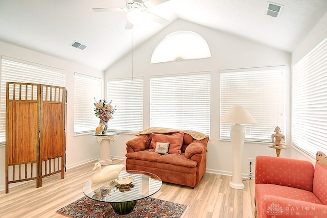 living room featuring ceiling fan, high vaulted ceiling, and light wood-type flooring