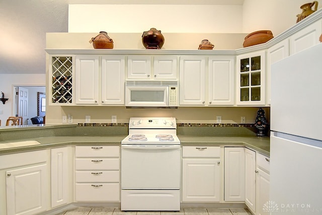 kitchen with white cabinets, sink, and white appliances