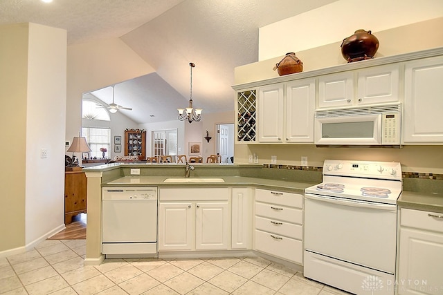 kitchen with white appliances, sink, vaulted ceiling, a textured ceiling, and ceiling fan with notable chandelier