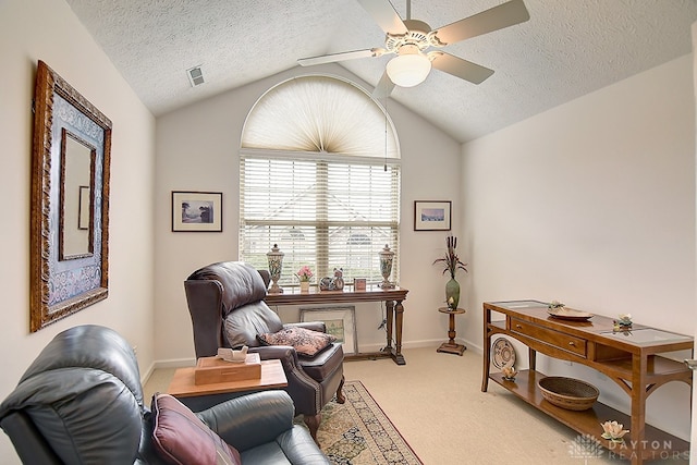 office featuring ceiling fan, a textured ceiling, lofted ceiling, and light colored carpet