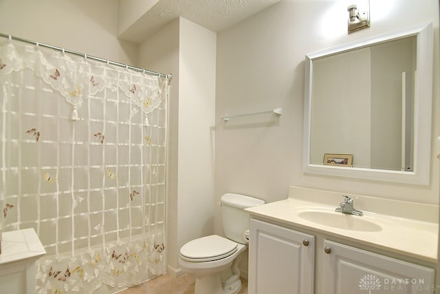 bathroom featuring vanity, a shower with shower curtain, a textured ceiling, and toilet