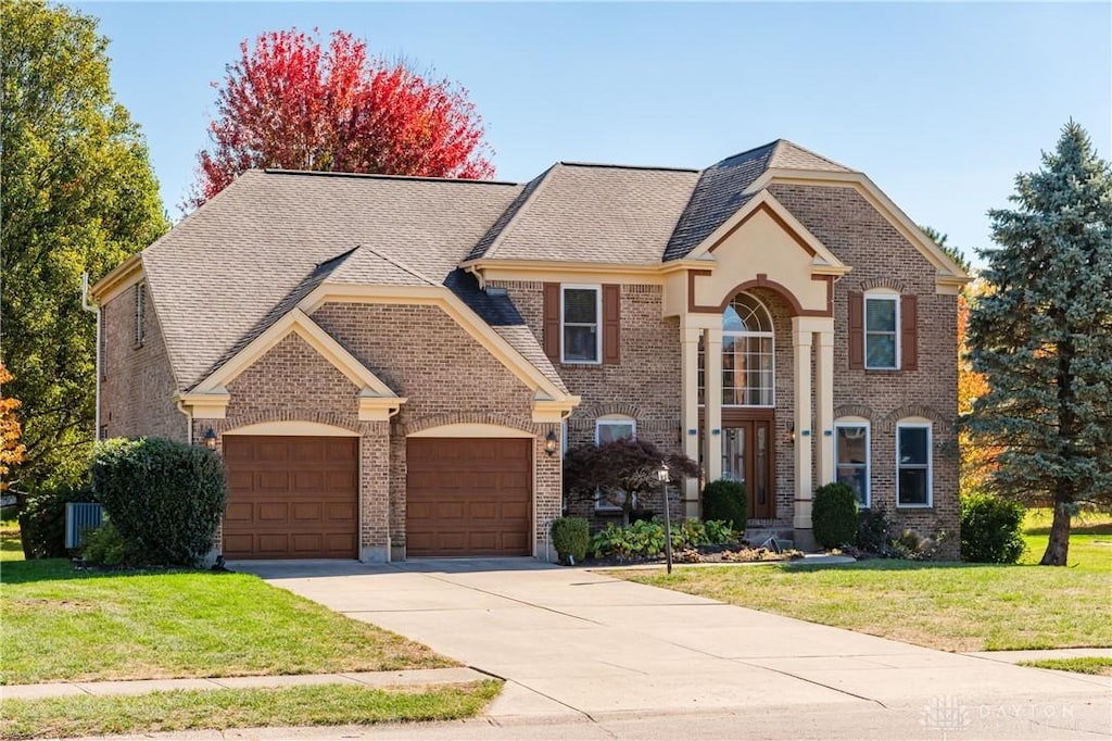 view of front of house featuring a front yard and a garage