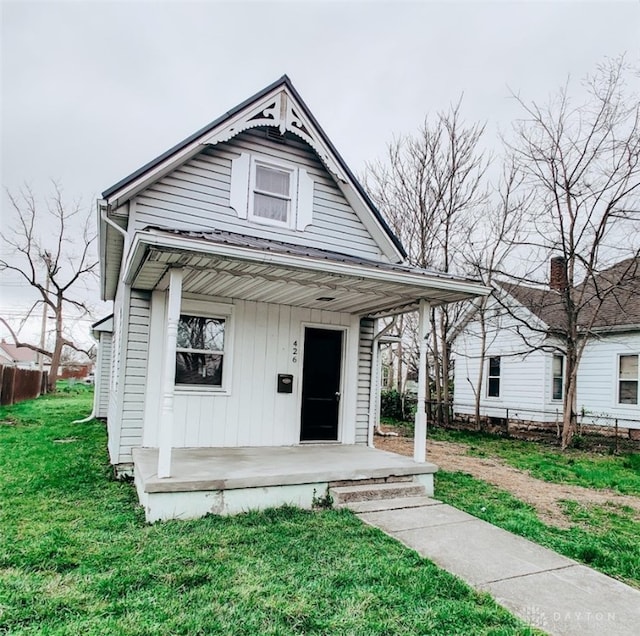 view of front of home with a front yard and a porch