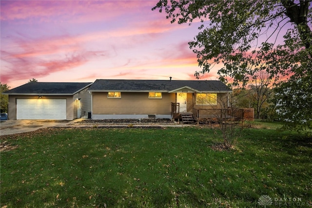 ranch-style house with a lawn and a garage