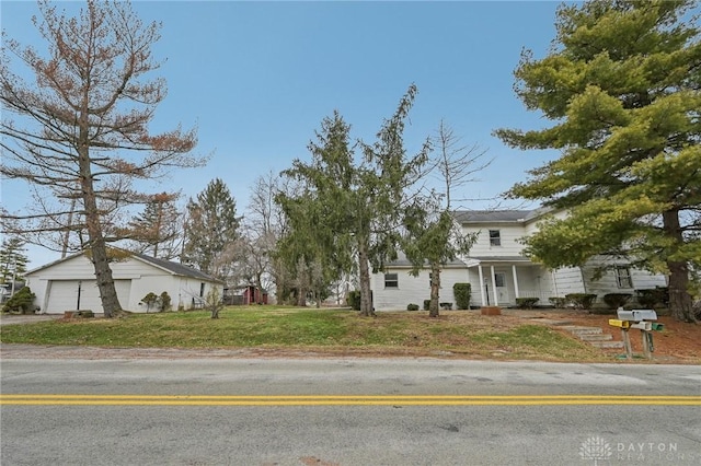 view of front of home featuring a garage and a front lawn