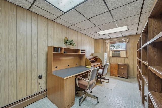 office area with cooling unit, a paneled ceiling, wooden walls, and a baseboard radiator