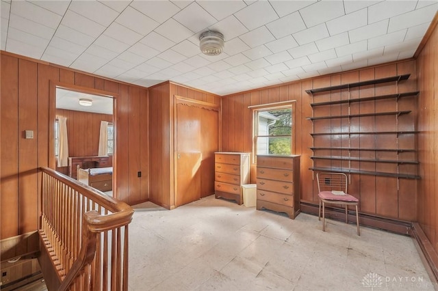 interior space featuring a baseboard heating unit and wood walls