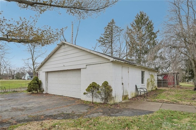 view of side of property with an outbuilding and a garage