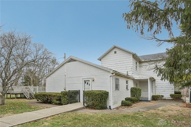 view of property exterior featuring a lawn