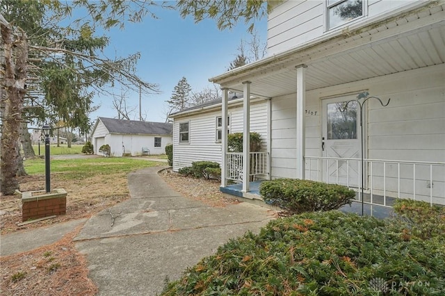 view of property exterior with covered porch and a lawn