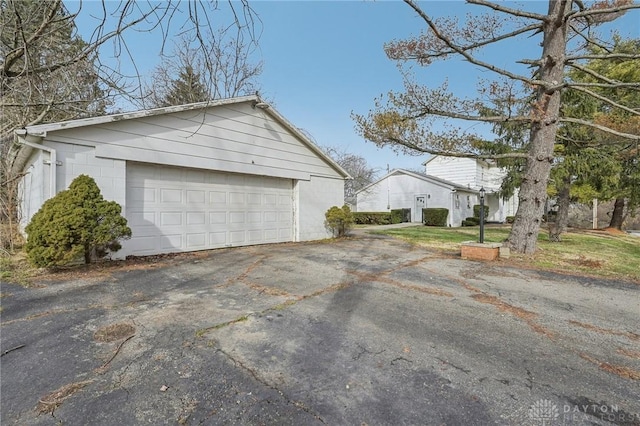 view of home's exterior with a garage and an outdoor structure