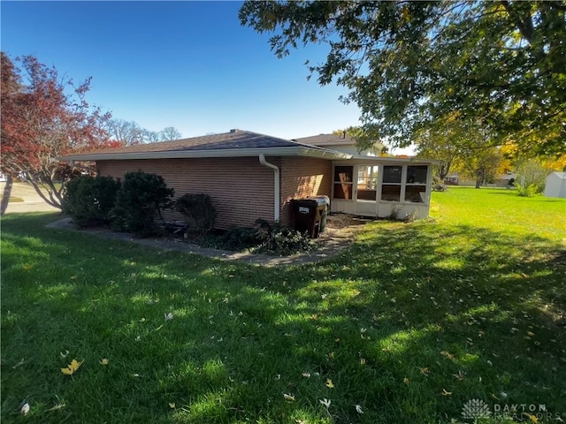 rear view of house with a yard