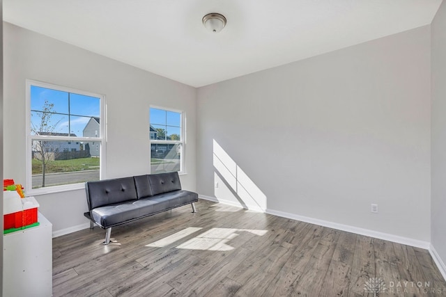 living area with hardwood / wood-style floors and a healthy amount of sunlight