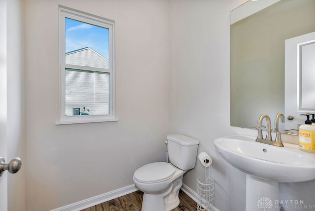 bathroom featuring sink, hardwood / wood-style floors, and toilet