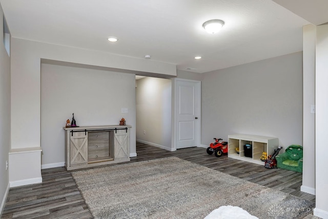 playroom with dark wood-type flooring