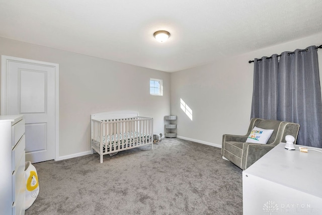 bedroom with light colored carpet and a nursery area