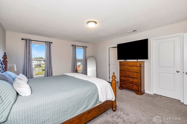 carpeted bedroom with a textured ceiling